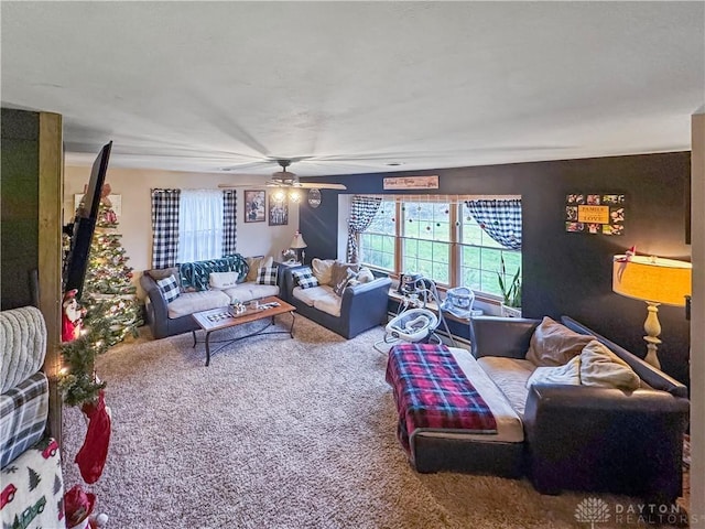 living room with ceiling fan and carpet