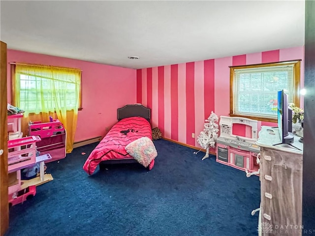 carpeted bedroom featuring baseboard heating and multiple windows