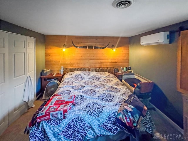 bedroom with an AC wall unit, wooden walls, and a closet