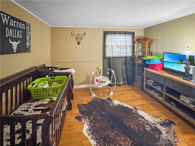 bedroom featuring crown molding and hardwood / wood-style flooring