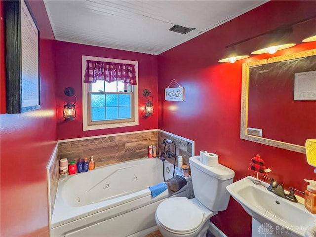 bathroom featuring toilet, a bathing tub, and sink