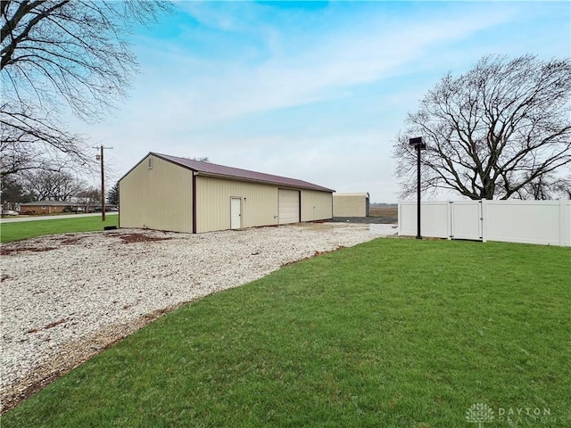 view of side of home featuring a yard and an outdoor structure