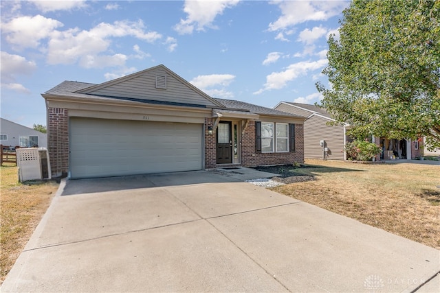 ranch-style house with a garage and a front lawn