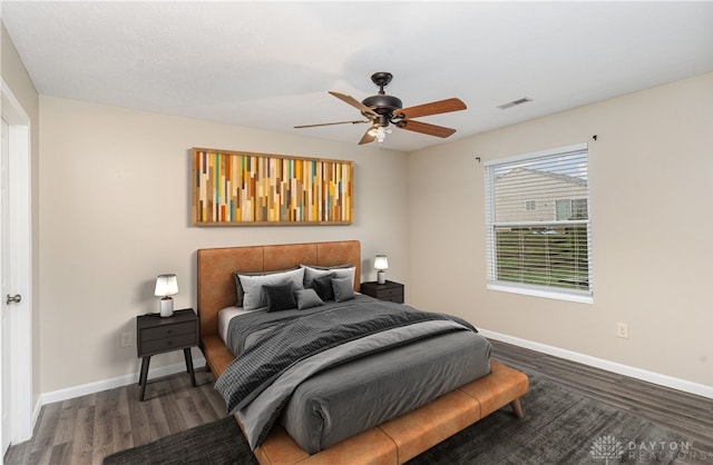 bedroom with ceiling fan and dark wood-type flooring