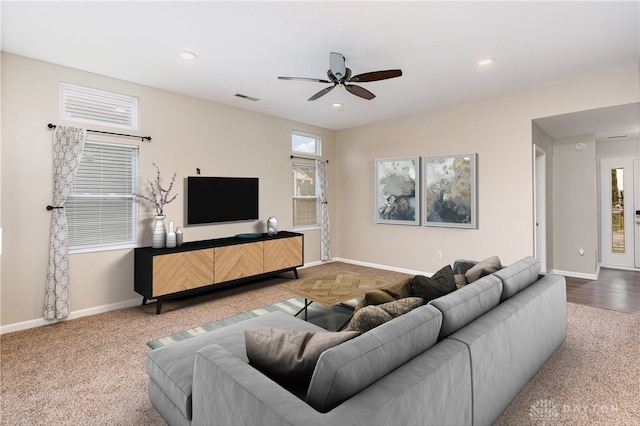 carpeted living room featuring ceiling fan