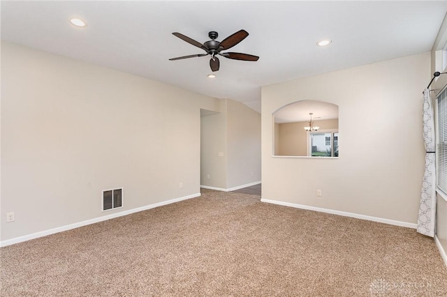 spare room with carpet and ceiling fan with notable chandelier