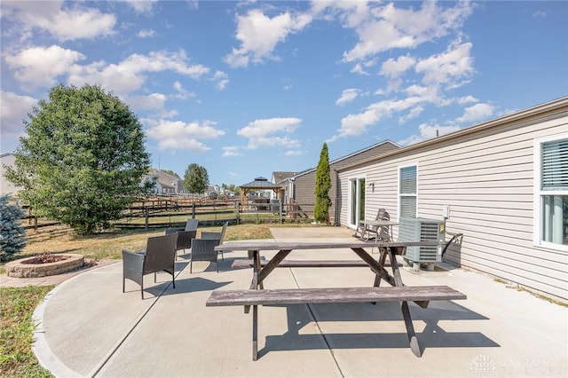 view of patio / terrace with a gazebo, central AC, and a fire pit