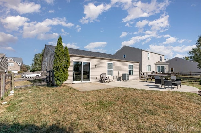 back of property featuring a yard, a patio, and central AC