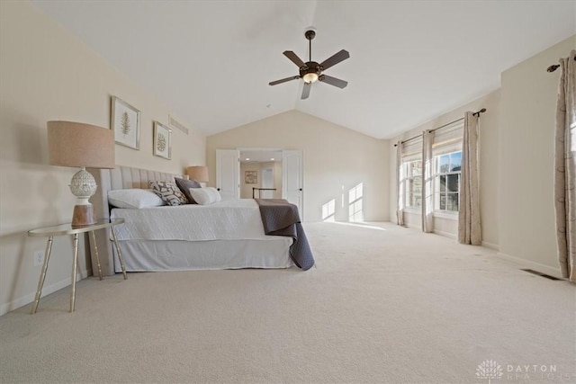 carpeted bedroom with ceiling fan and vaulted ceiling