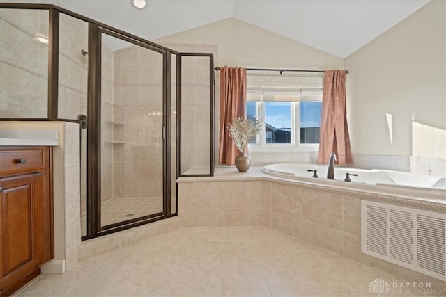 bathroom featuring tile patterned flooring, vanity, separate shower and tub, and lofted ceiling