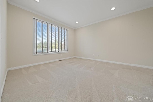 carpeted spare room with crown molding