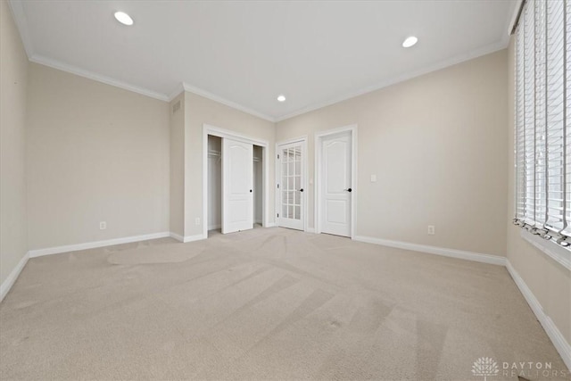 unfurnished bedroom featuring crown molding and light colored carpet