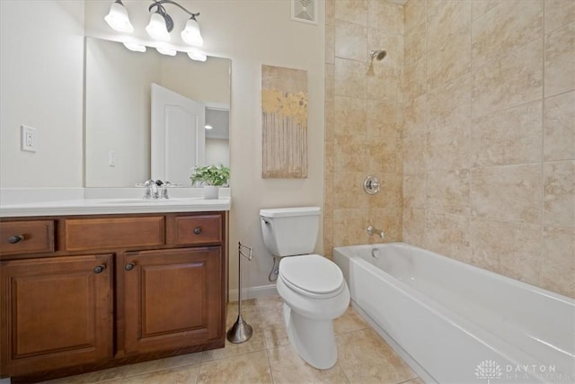 full bathroom featuring tile patterned floors, tiled shower / bath combo, toilet, and vanity