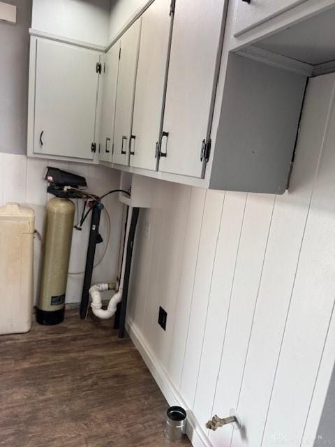 laundry area with dark wood-type flooring