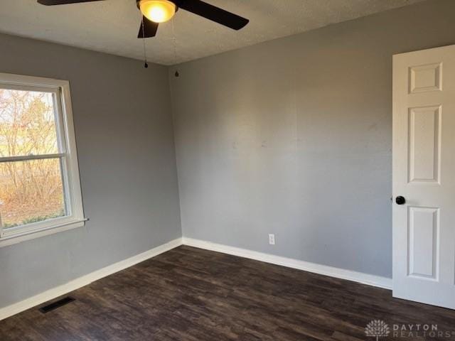 spare room featuring ceiling fan and dark hardwood / wood-style floors