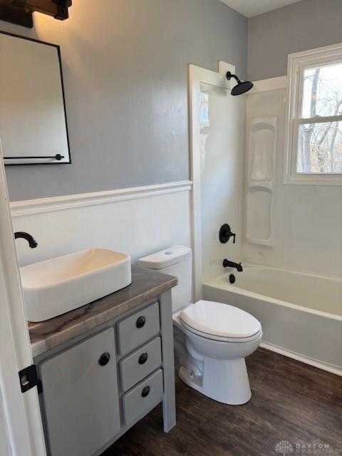 full bathroom featuring hardwood / wood-style flooring, vanity, toilet, and bathing tub / shower combination