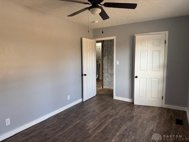 unfurnished bedroom with ceiling fan, dark wood-type flooring, and a textured ceiling