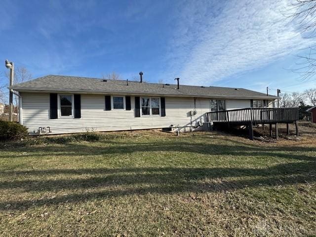 back of house featuring a yard and a wooden deck