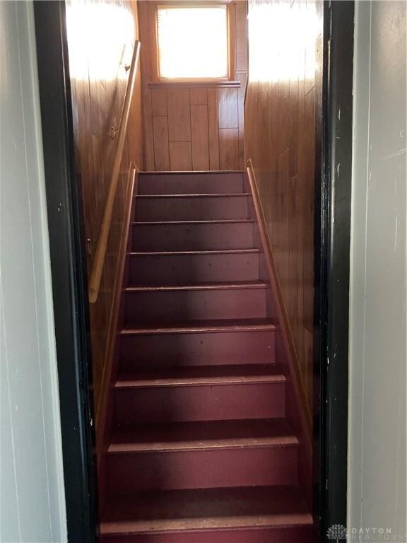 staircase with wood walls