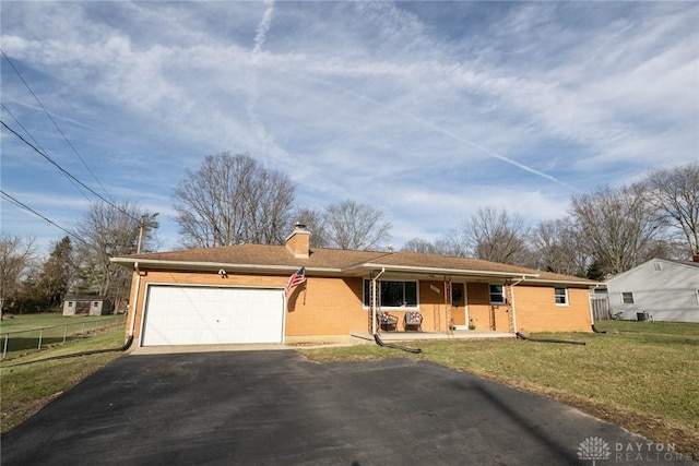 ranch-style house featuring a garage, a porch, and a front lawn