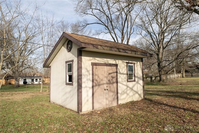 view of outdoor structure featuring a lawn