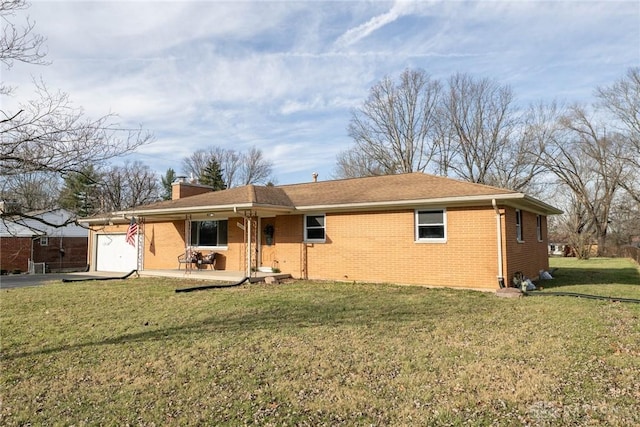 rear view of property with a lawn