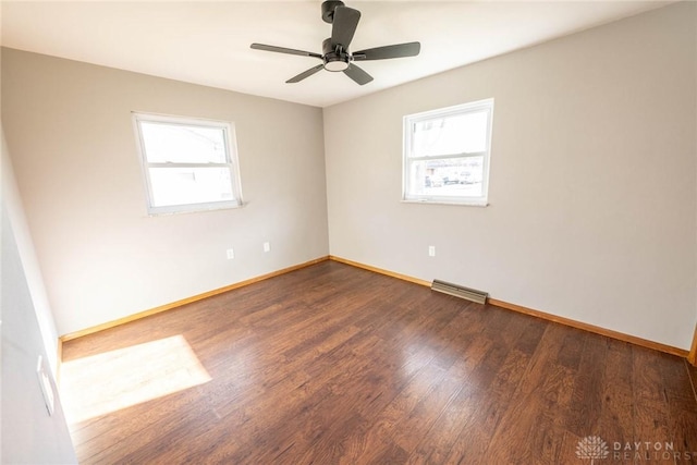 empty room with dark wood-type flooring and ceiling fan