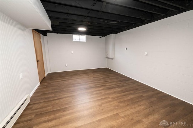 basement featuring baseboard heating and wood-type flooring