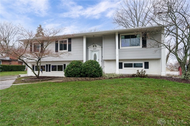 raised ranch featuring a front lawn