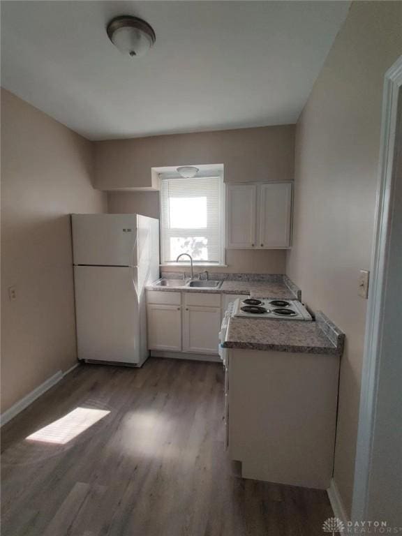 kitchen with white cabinets, white appliances, dark wood-type flooring, and sink