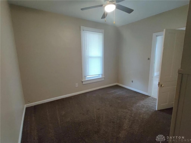 carpeted spare room with ceiling fan