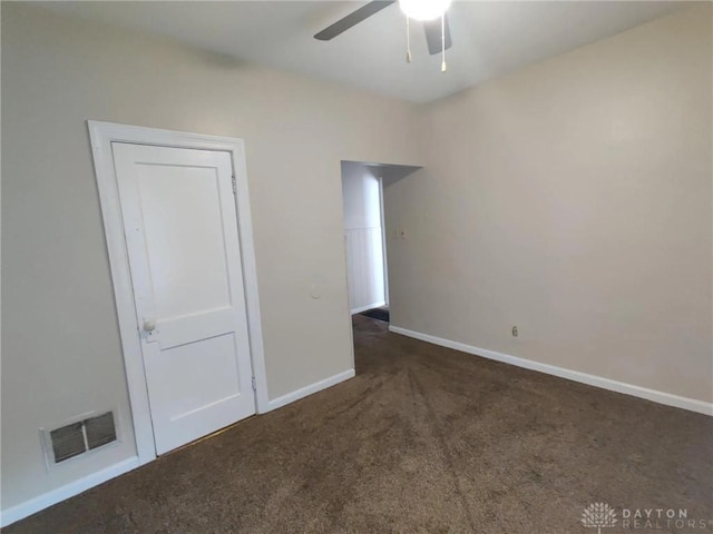 unfurnished room featuring ceiling fan and dark carpet