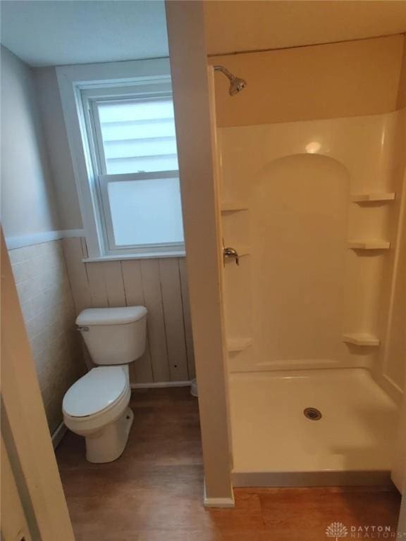 bathroom with toilet and walk in shower