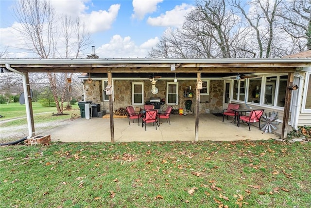 back of house with a lawn and a patio