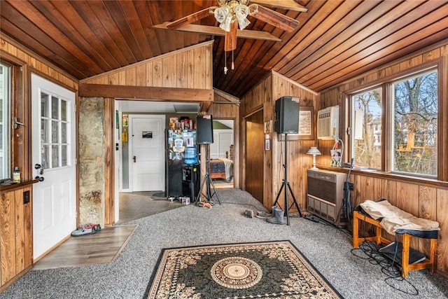 sunroom / solarium featuring ceiling fan, wooden ceiling, a wall unit AC, and vaulted ceiling