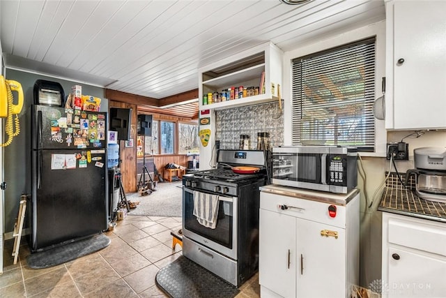 kitchen with light carpet, white cabinets, a healthy amount of sunlight, and appliances with stainless steel finishes