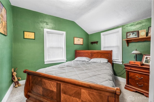 bedroom with carpet, lofted ceiling, and a textured ceiling