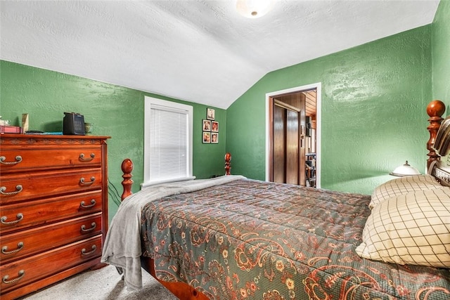 bedroom featuring carpet flooring, a textured ceiling, and vaulted ceiling