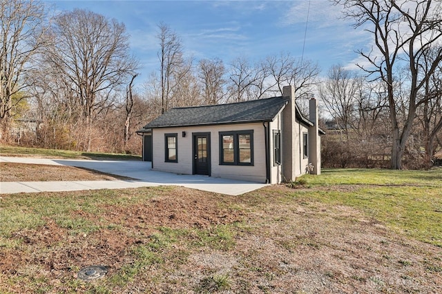 view of outbuilding featuring a yard