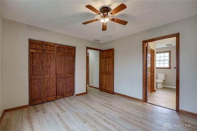 unfurnished bedroom with light wood-type flooring, ensuite bath, a textured ceiling, ceiling fan, and a closet