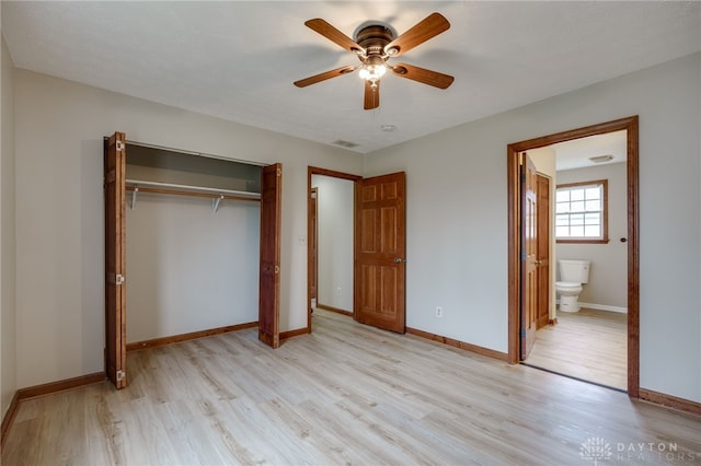 unfurnished bedroom featuring a closet, ensuite bathroom, light hardwood / wood-style flooring, and ceiling fan