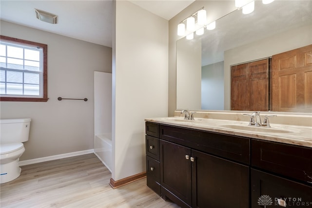 bathroom featuring hardwood / wood-style floors, vanity, and toilet