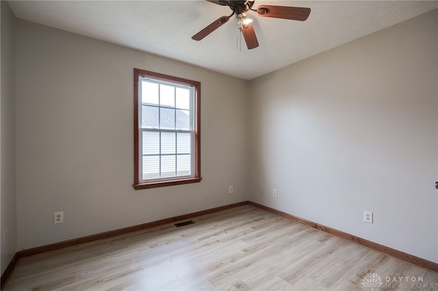 spare room with light wood-type flooring and ceiling fan