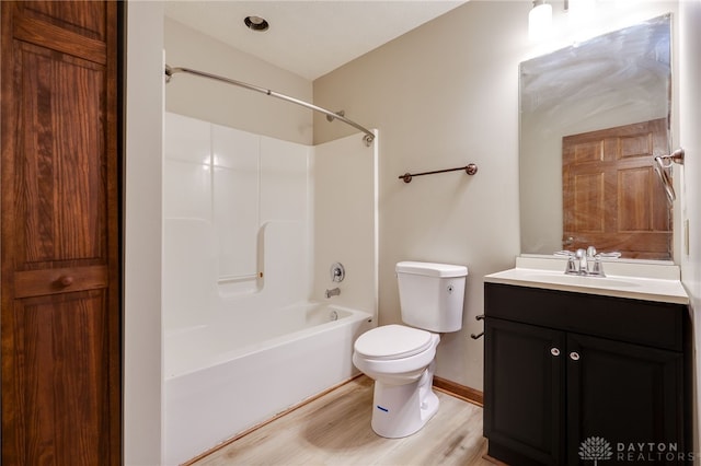 full bathroom featuring shower / bathing tub combination, wood-type flooring, vaulted ceiling, toilet, and vanity