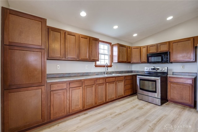 kitchen featuring sink, stainless steel range with electric cooktop, lofted ceiling, and light wood-type flooring