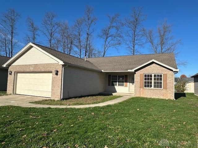 single story home featuring a front yard and a garage