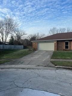 view of front of home featuring a garage and a yard