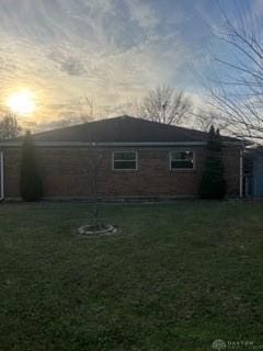 back house at dusk with a yard