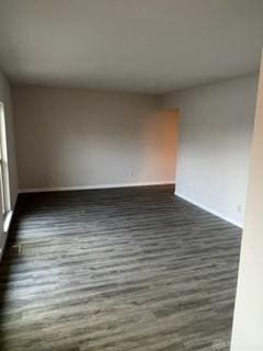 unfurnished room featuring dark wood-type flooring