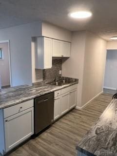 kitchen featuring dishwasher, white cabinets, and dark wood-type flooring